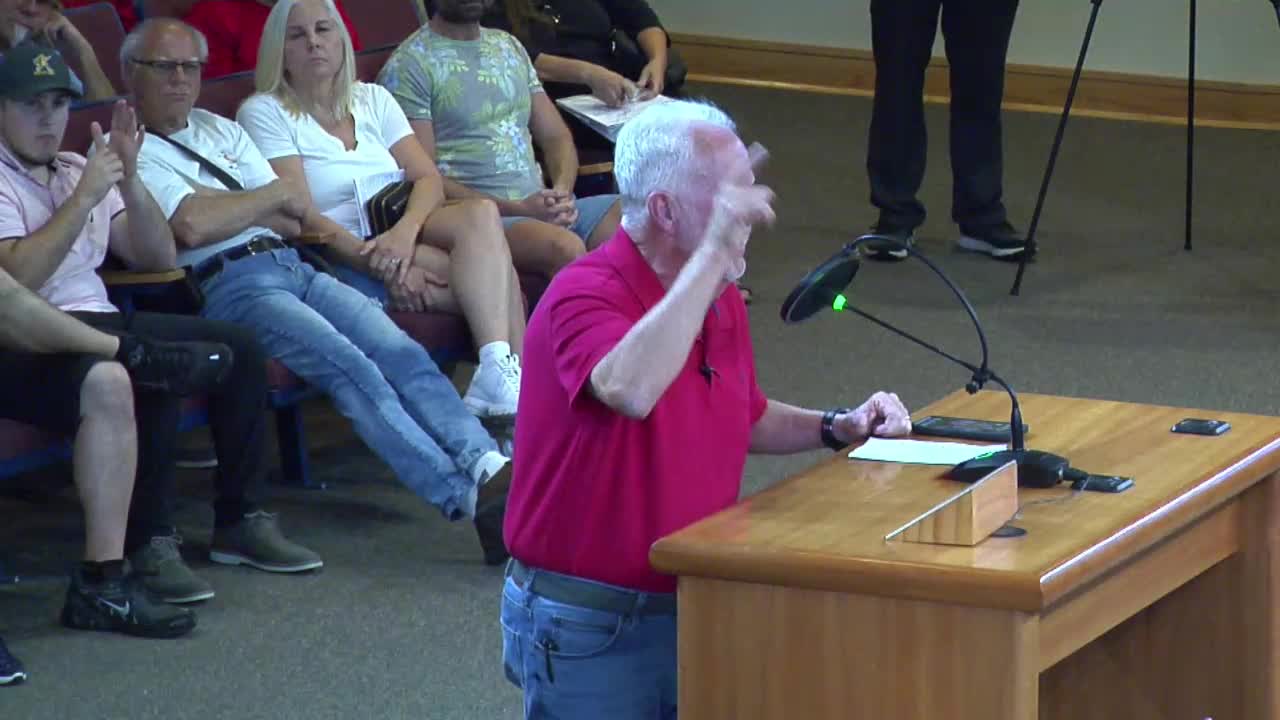 Young Resident Challenges Development Plans at County Meeting