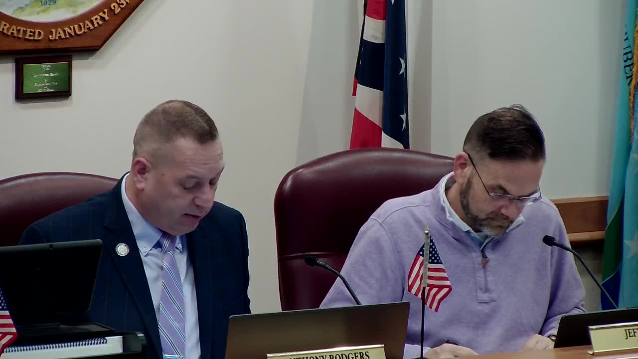 Council approves organizational chart changes and pay-scale update; discussion focuses on police staffing shortages