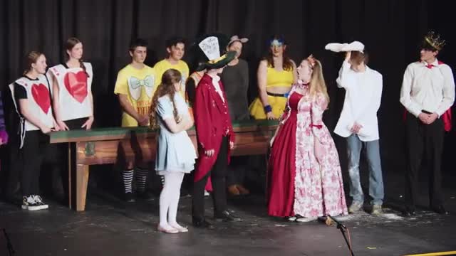 Alice challenges the Queen in Wonderland's chaotic courtroom showdown