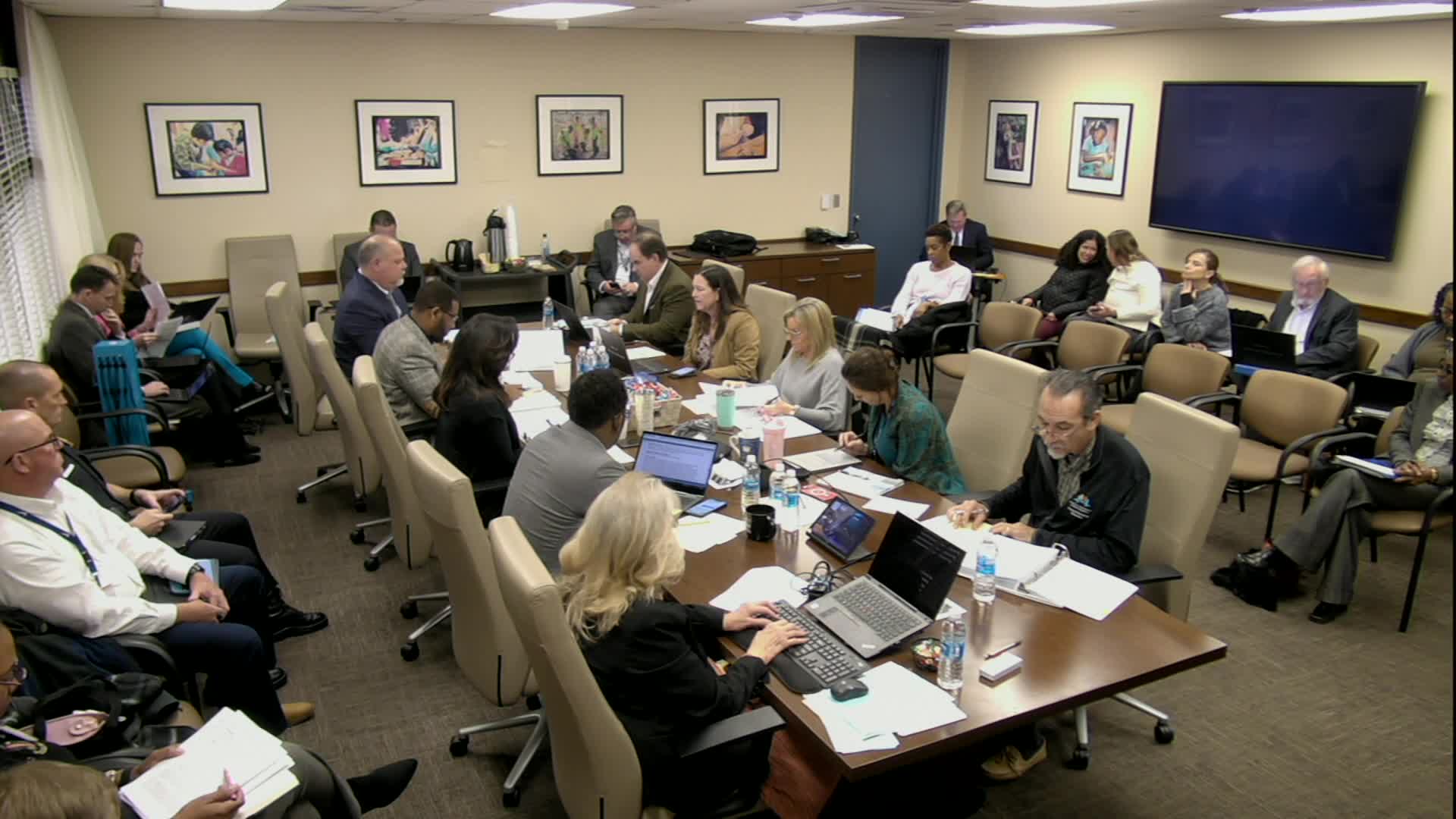 Board debates charter renewals and funding pass-throughs; requests detailed financial and enrollment charts