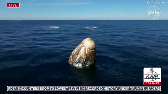 Recovery team approaches Dragon capsule after successful splashdown with NASA astronauts