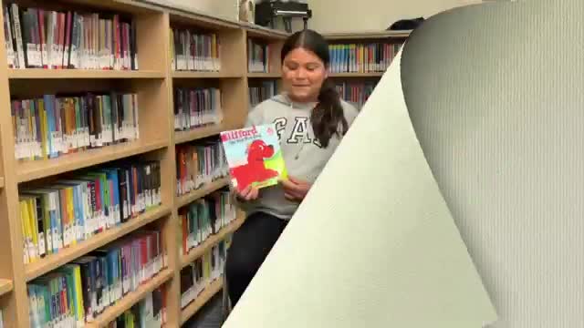 Emily Elizabeth shares adventures with Clifford the big red dog