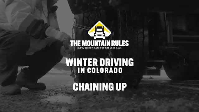 Transportation Commission staff demonstrates how to install tire chains