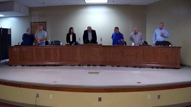Kevin Phelps leads prayer and pledge at county officials meeting