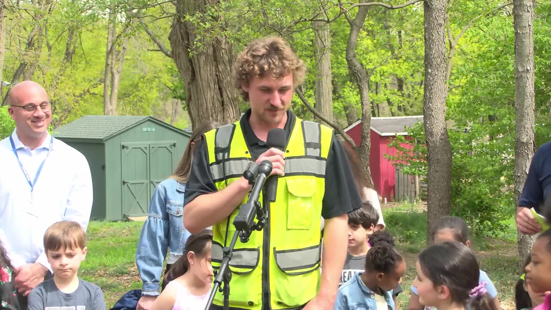 Nature expert identifies pink flowering dogwood tree during community discussion
