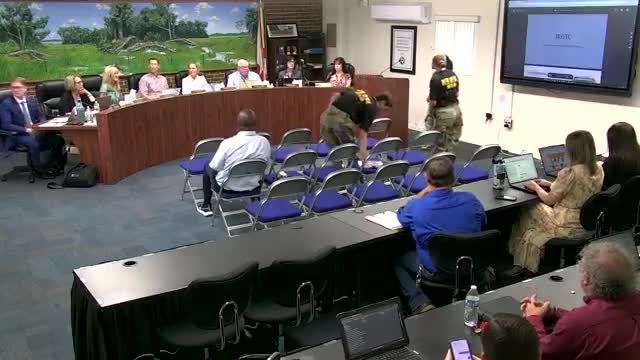 Students, instructor brief board on JROTC activities; funding cuts kept drill team from state meet