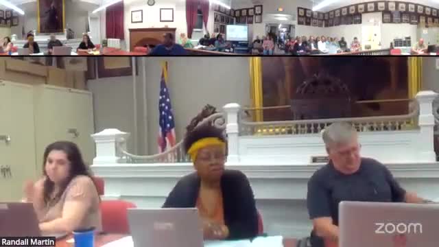 Developer presents revised mixed-use ‘Both Locks’ plan; board opens public hearing and requests conditions tying remote parking to site