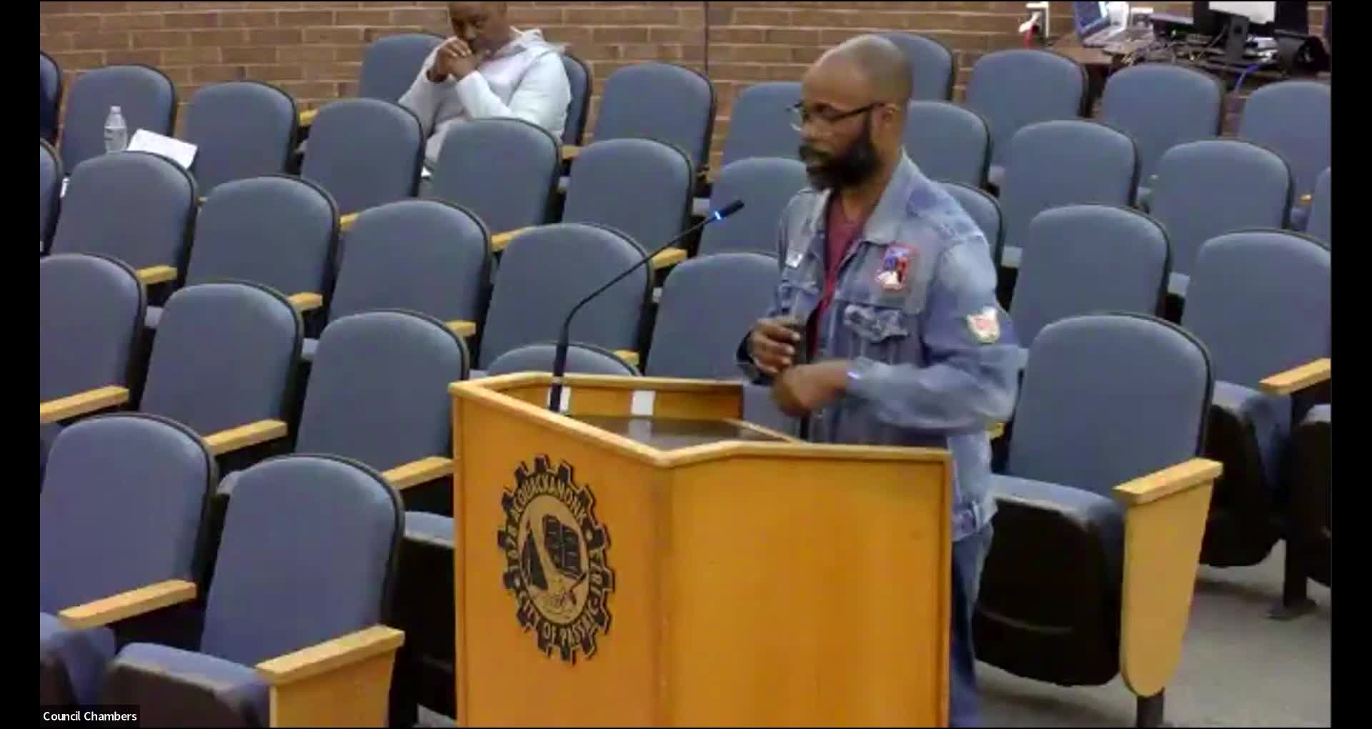 Parker Brown questions fence height and parking enforcement during city council meeting