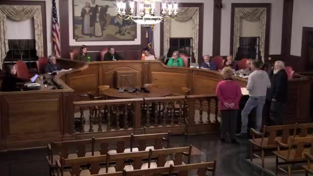 Homeowners contest wetlands designation affecting property rights in local commission meeting