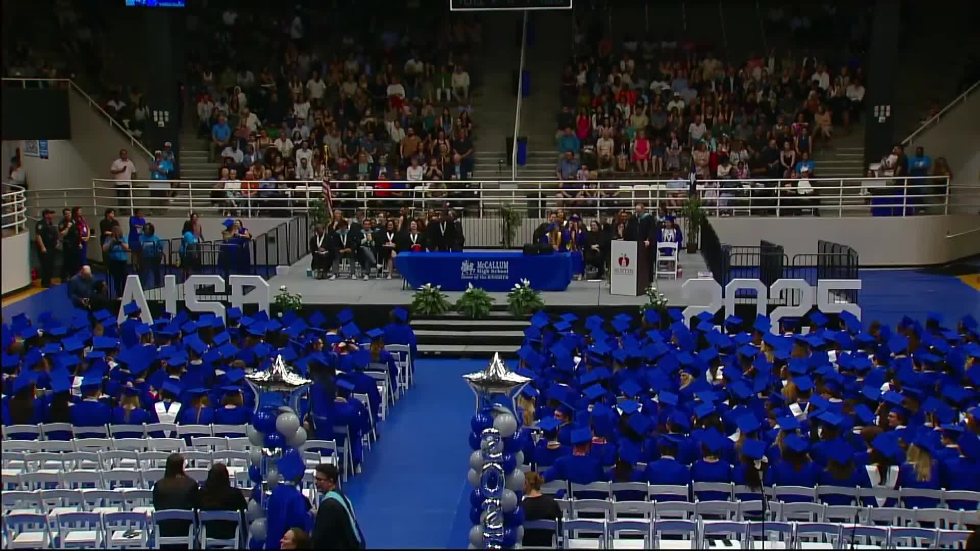 McCallum High School celebrates graduation with cap toss and school song