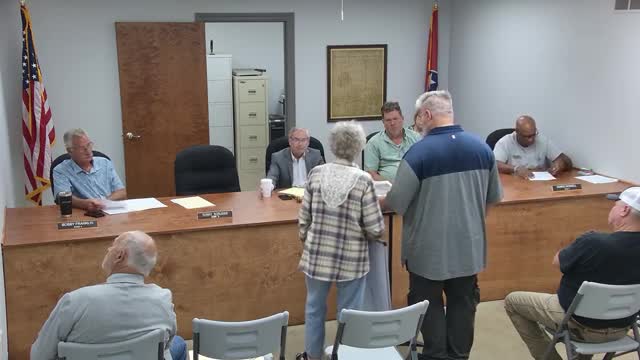 Local resident addresses flooding issues caused by neighboring property at community meeting