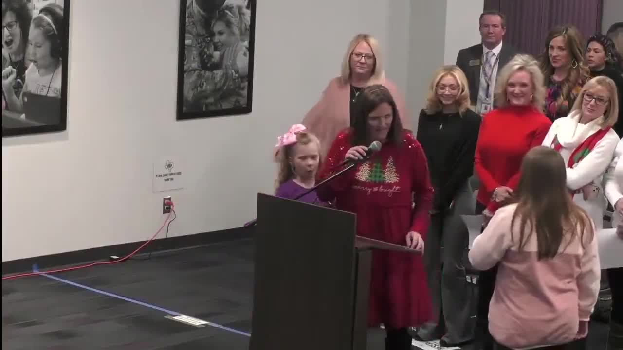 Izzy Mannes leads pledge of allegiance at school event