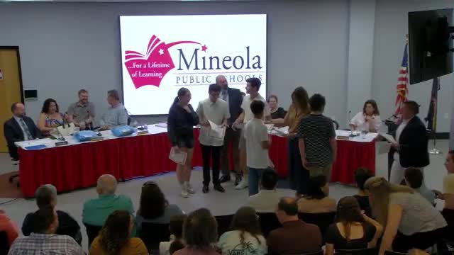 Andrew Wolsey presents robotics awards recognizing student achievements in competitions