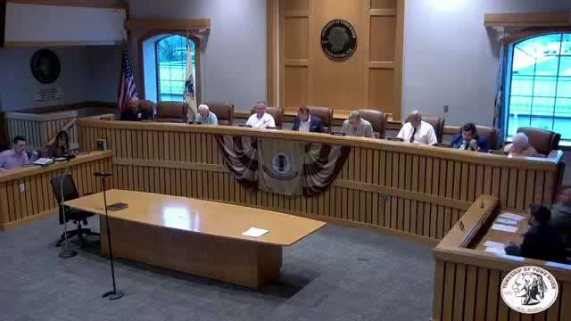 Council holds contentious first reading on new police hiring guidelines; critics say standards are lowered