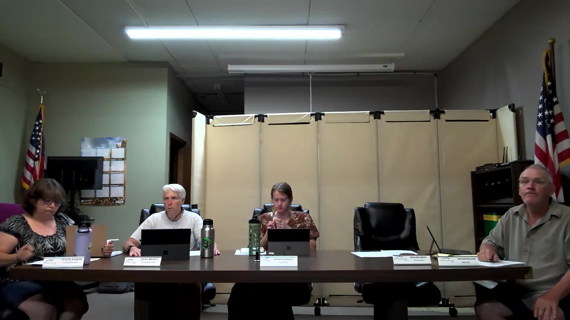 Sue Devlin questions status of longstanding agenda items at community meeting