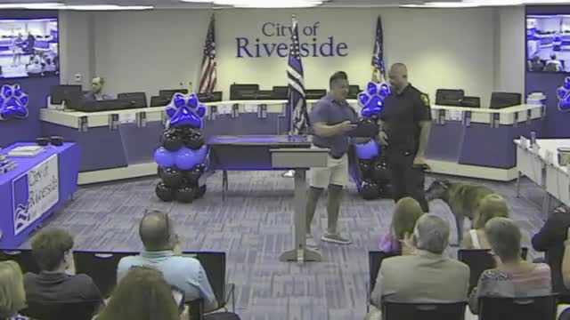 Montgomery County Auditor Carl Keith honors local dog handler Tina at Riverside event