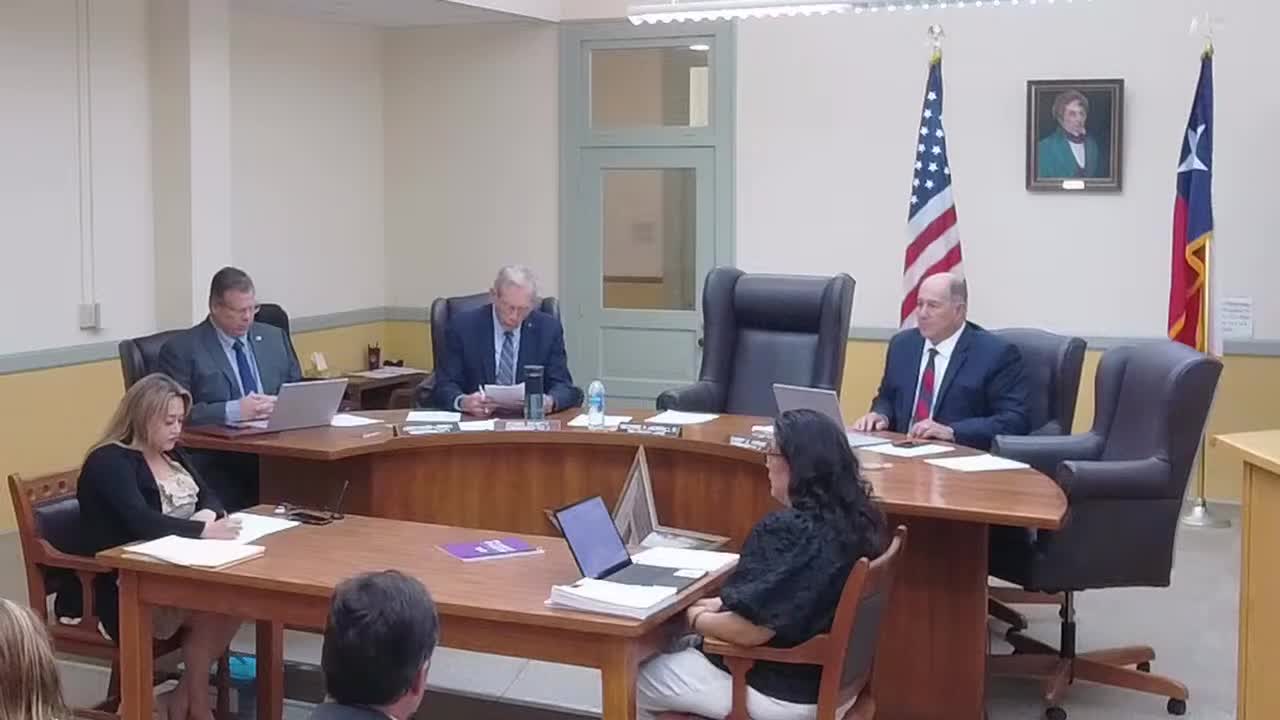 Father Andrew Green leads prayer for Texas flood victims at county meeting