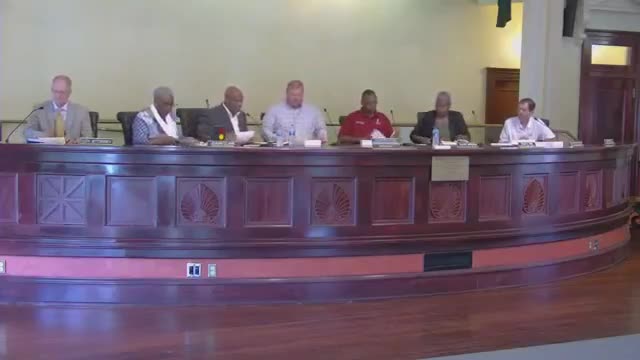 Pastor Willie Hopson leads prayer at July city council meeting