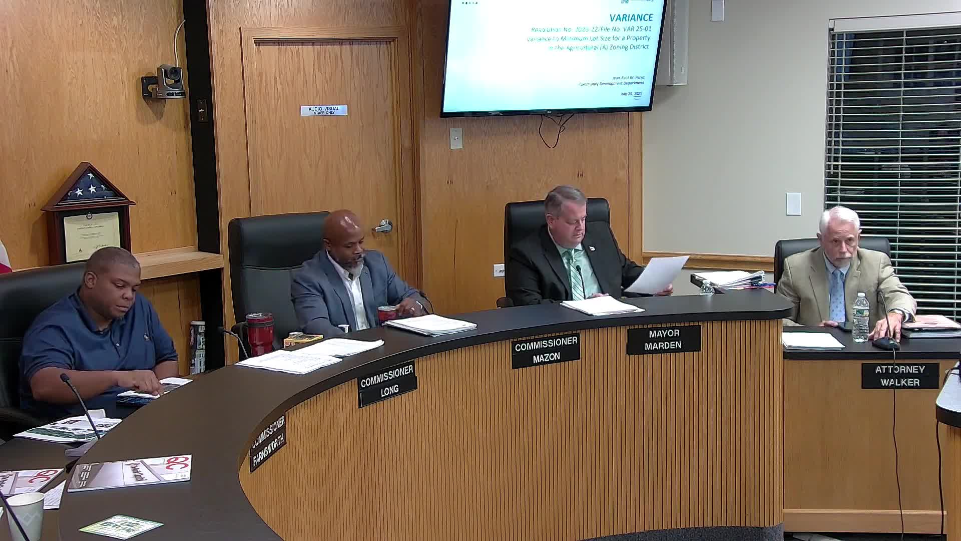 Board of Adjustment grants variance to allow two-lot division where right-of-way reduced gross acreage