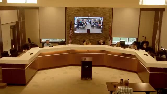 Aldermen approve holding detention-basin escrow while accepting streets; city to press developer for fixes