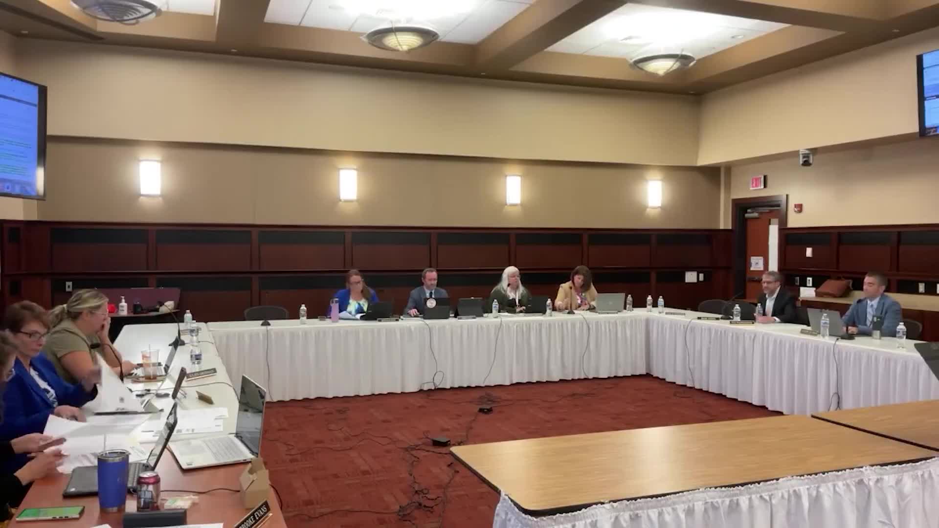 Committee debates wording and authority language in employee freedom‑of‑speech policy