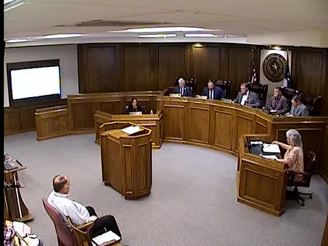 Commissioner Jason Corley leads invocation and pledges at county meeting