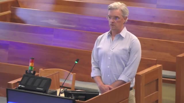 Homeowner Addresses Privacy Concerns Over Neighbor's Fence at Local Board Meeting