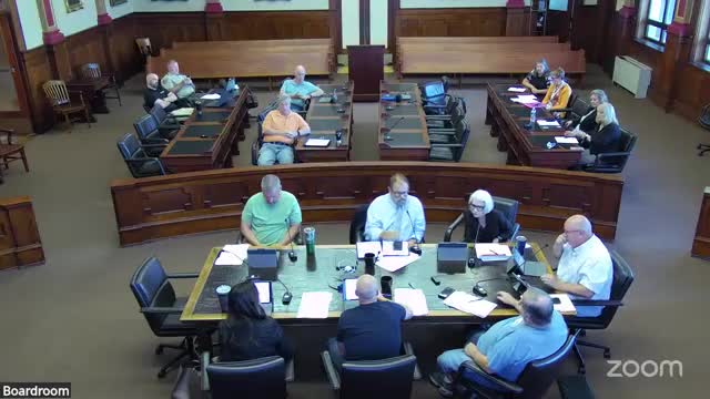 Finance committee advances resolution to establish full‑time public defender position; state share expected to cover most salary