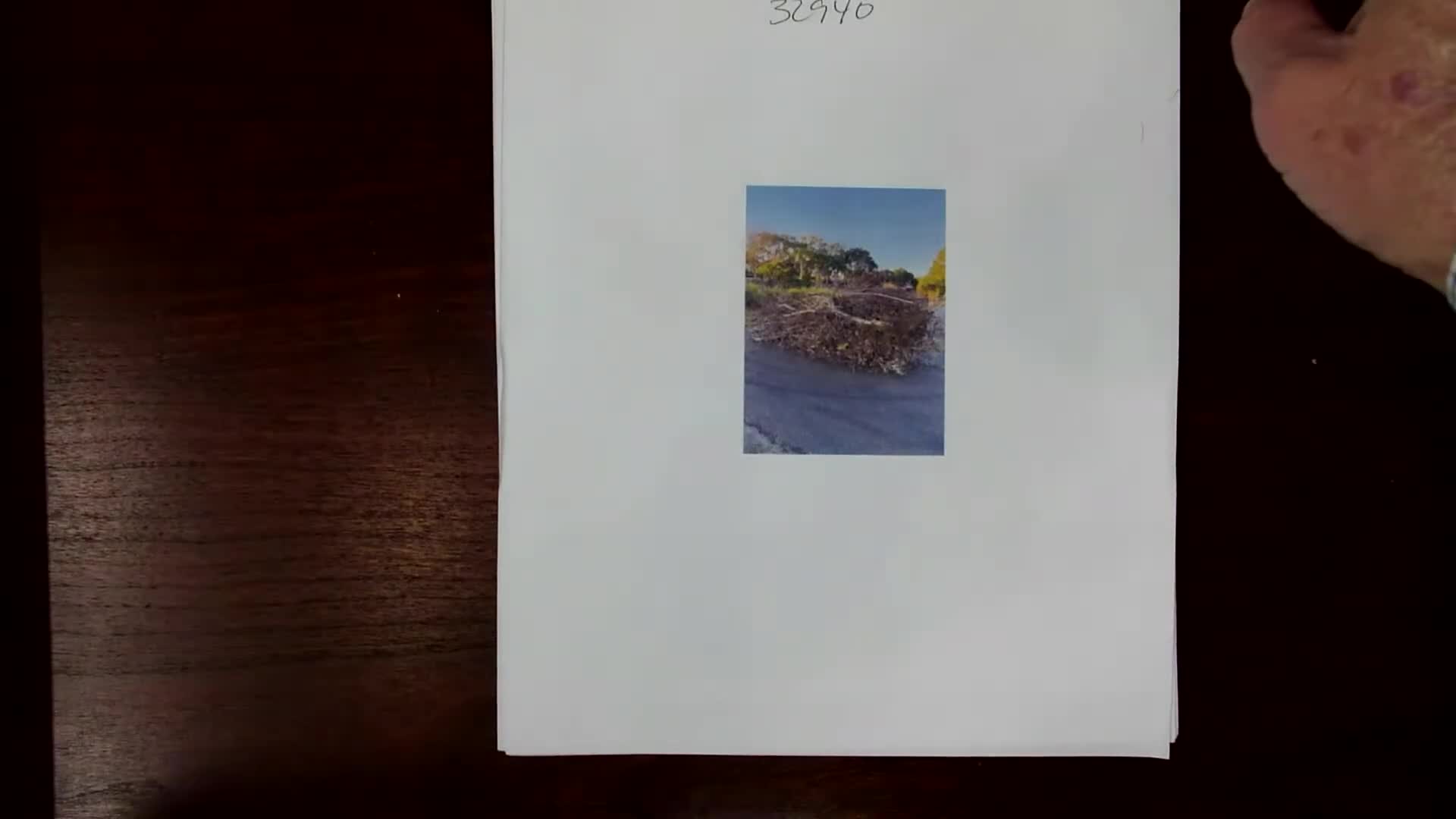 Resident shows commissioners photos of illegal dumping, urges county-mulch contract to reduce roadside trash