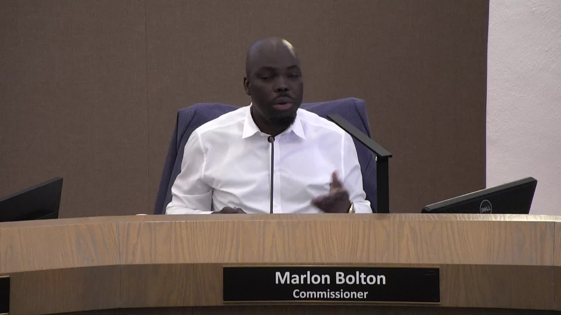 Commissioner Wright discusses budget allocations and travel expenses during city council meeting