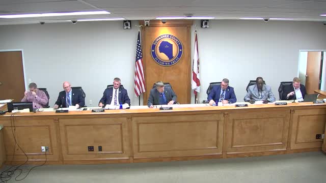 County attorney authorized to terminate EMS medical director contract; replacement named