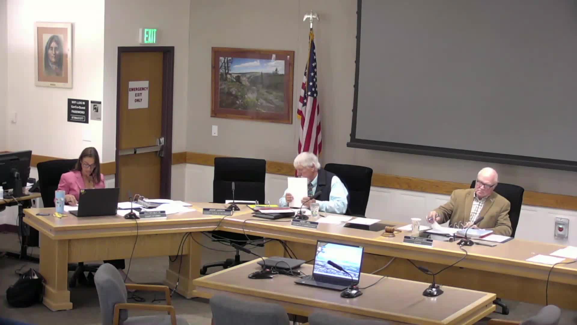 Commissioners debate proposed IGA on library trustee reappointments; no action taken