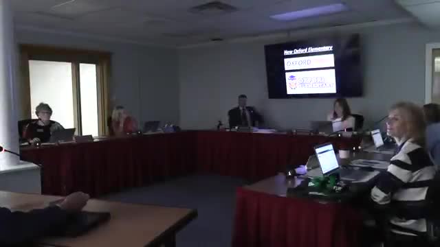 Board hears Oxford Elementary construction update and approves change order 002 to reduce long‑term water charges