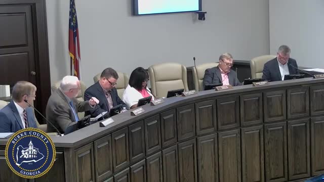 Commissioners discuss amending bid‑opening rules and a proposed facilities/IT reorganization; both items tabled for further work