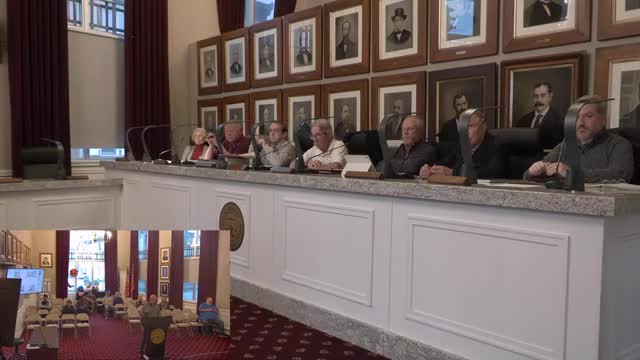 Board allows replacement of two upper‑story windows at 221 East Main with condition to match historic profile