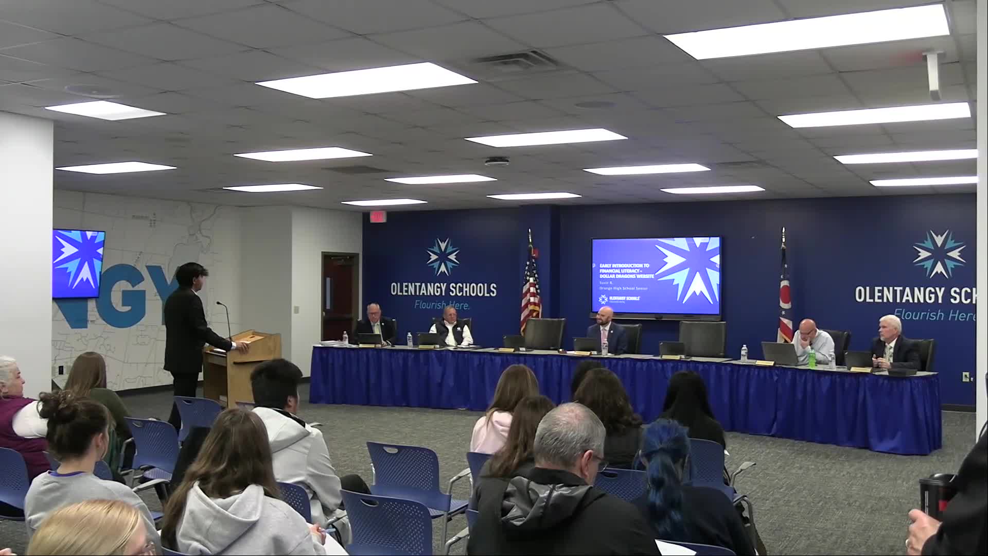 High school student demos 'Dollar Dragons' app to Olentangy board; 8 schools piloting K–5 rollout