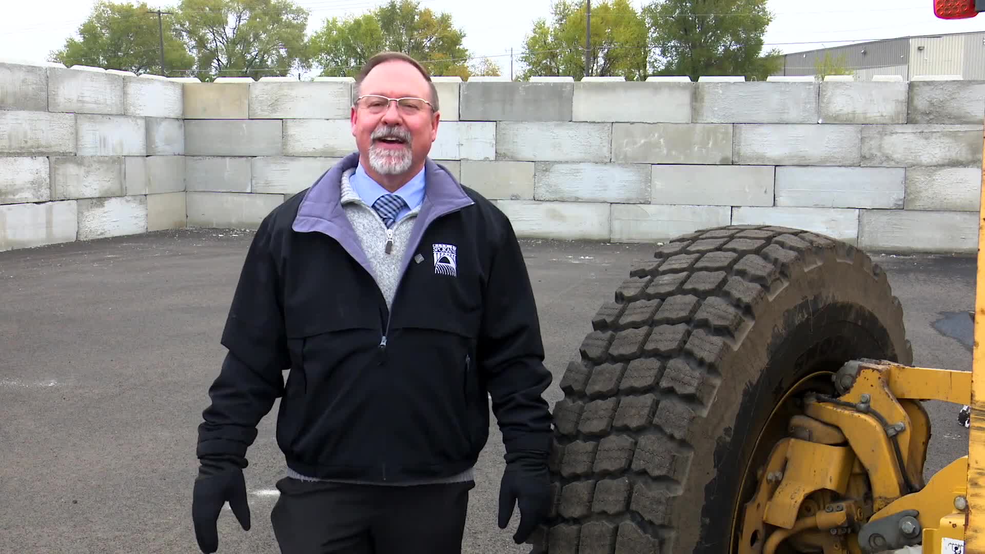 Spokane street crews replace heavy chains with specialized snow tires on graders