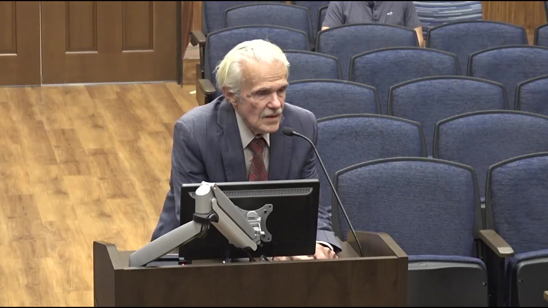 Resident questions district curriculum access and references governor's executive order during public comment