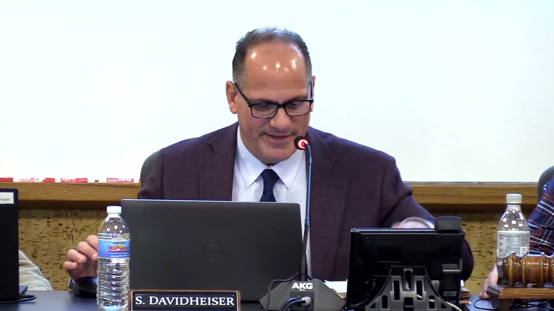 Consultants present 10‑year enrollment projections showing modest decline, urging household census