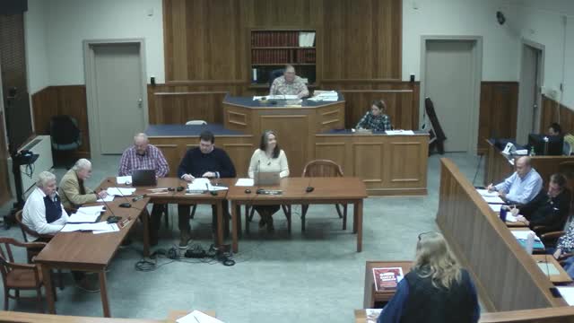 Resident challenges downtown placard-numbered parking signs; public works cites residential-application ordinance