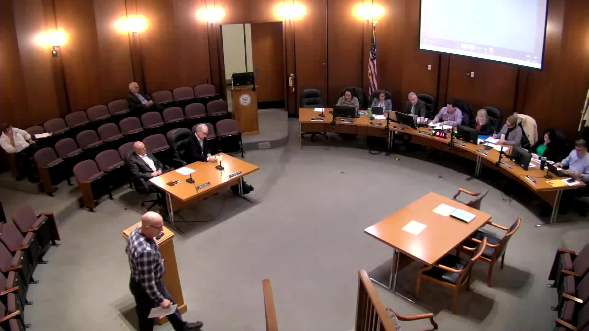 Resident urges council to link water‑rate increases to customer app; solicitor says service components must be defined