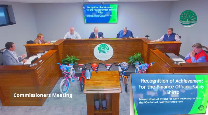 County presents U.S. Capitol‑flown flag to local veteran Ray Holloway; finance officer recognized for top cash management scores