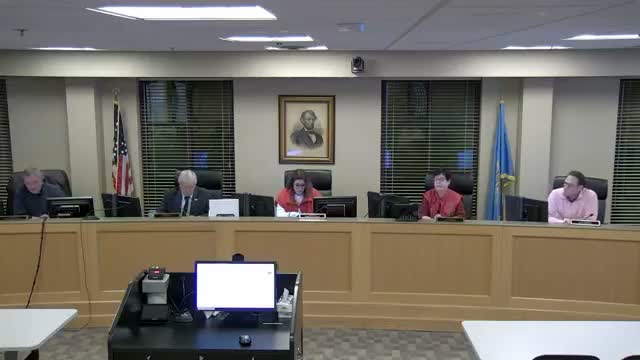 Commission debates lien compromise request after applicant cites wrongful arrest; record unclear on final outcome