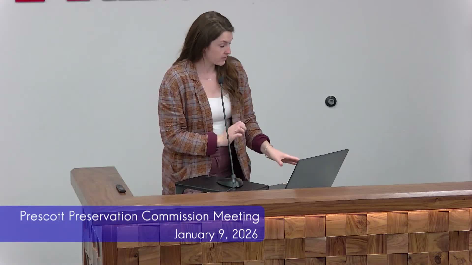 Planning staff reports completed siding work at 402–410 E. Goodwin; asks commission on brick caps