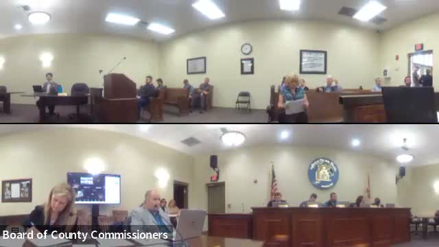 Commission approves county‑manager recruitment advertisement; board debates salary range