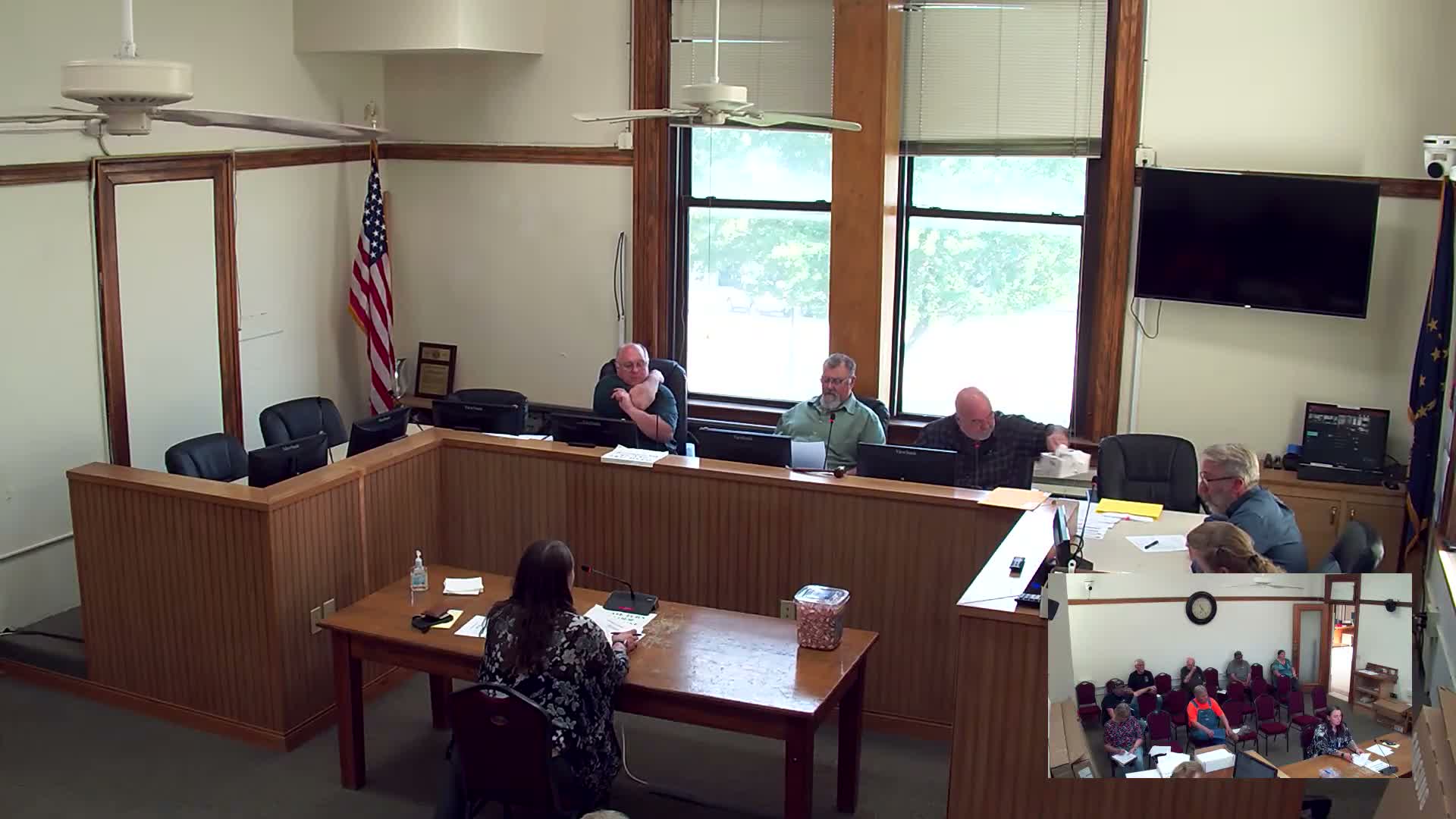 Building official presents permit fee increases; commissioners table changes for legal review and vote on May 7